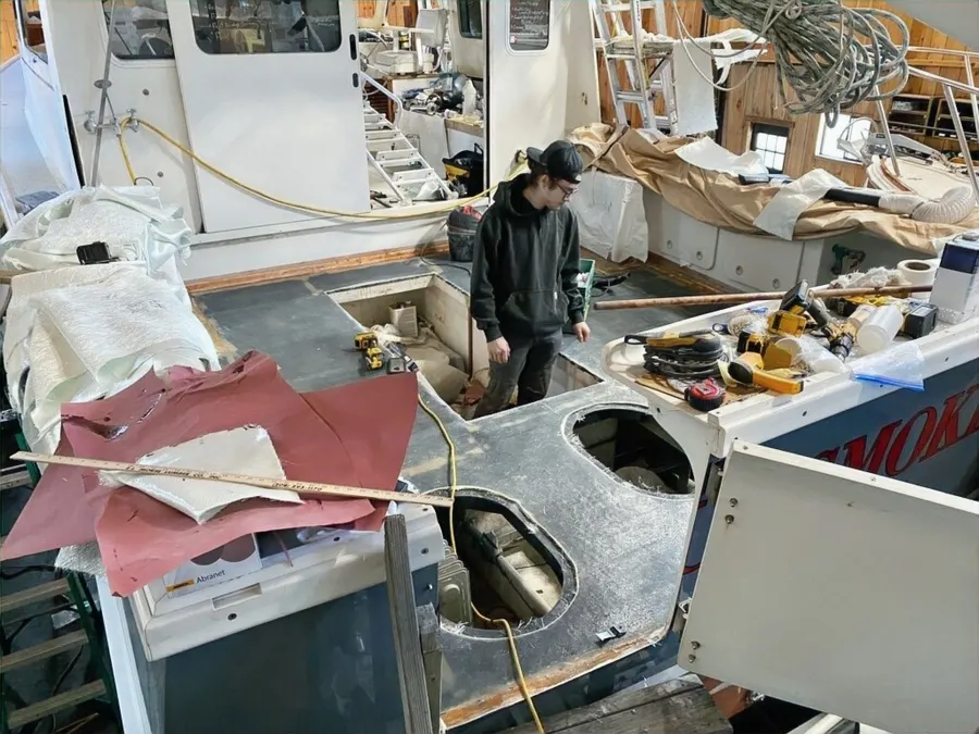 Crew member working on a boat interior